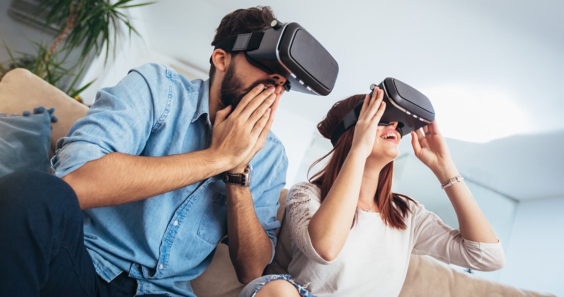 Two people on VR headsets playing a game
