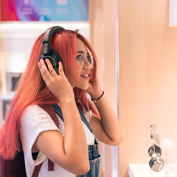 Woman using over ear headphones