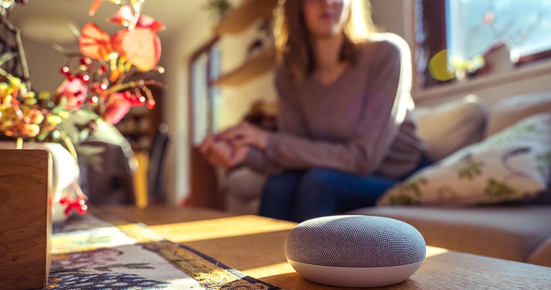 Smart speaker sitting on coffee table in woman's home