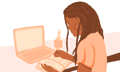 Woman working at desk with notebook, laptop, and water bottle