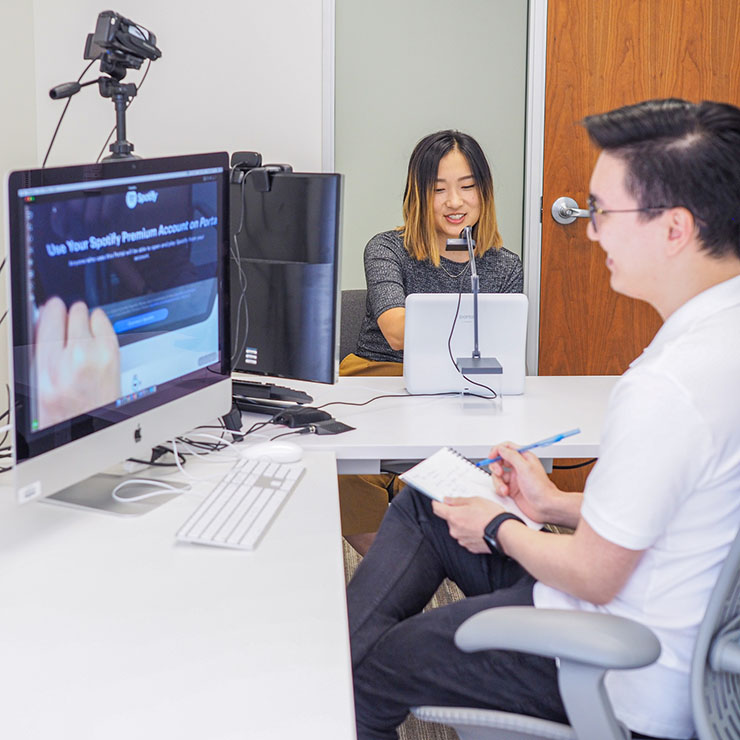 Researcher and participant conducting research in a UX lab