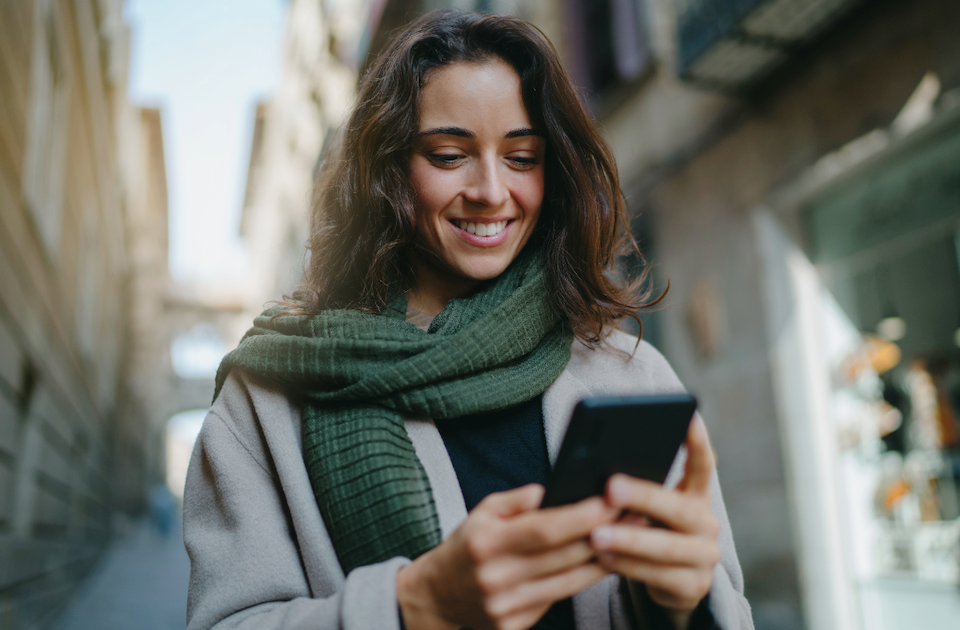 Woman out in a city environment using her phone