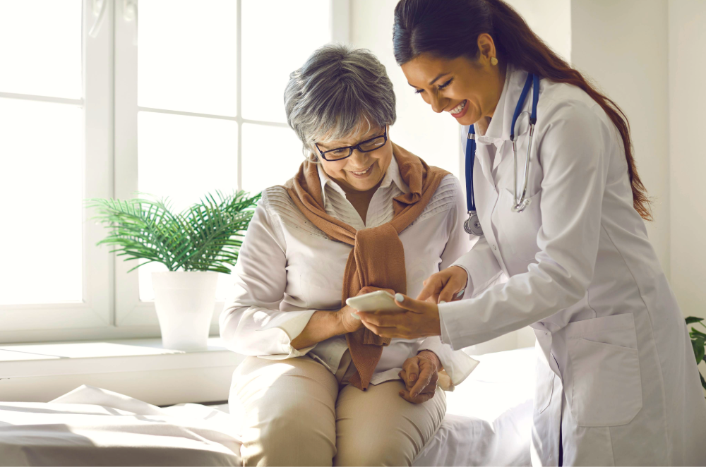 Doctor teaches female patient to use a healthcare device