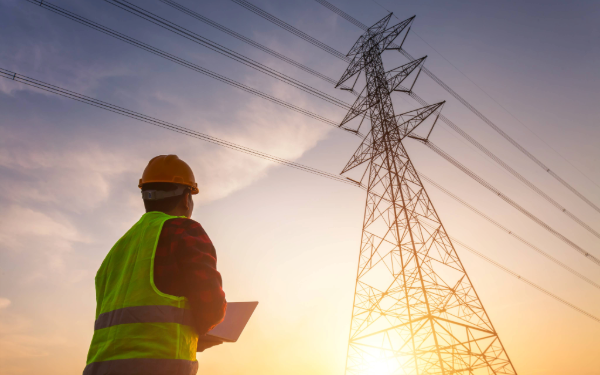man in hard hat working near power lines