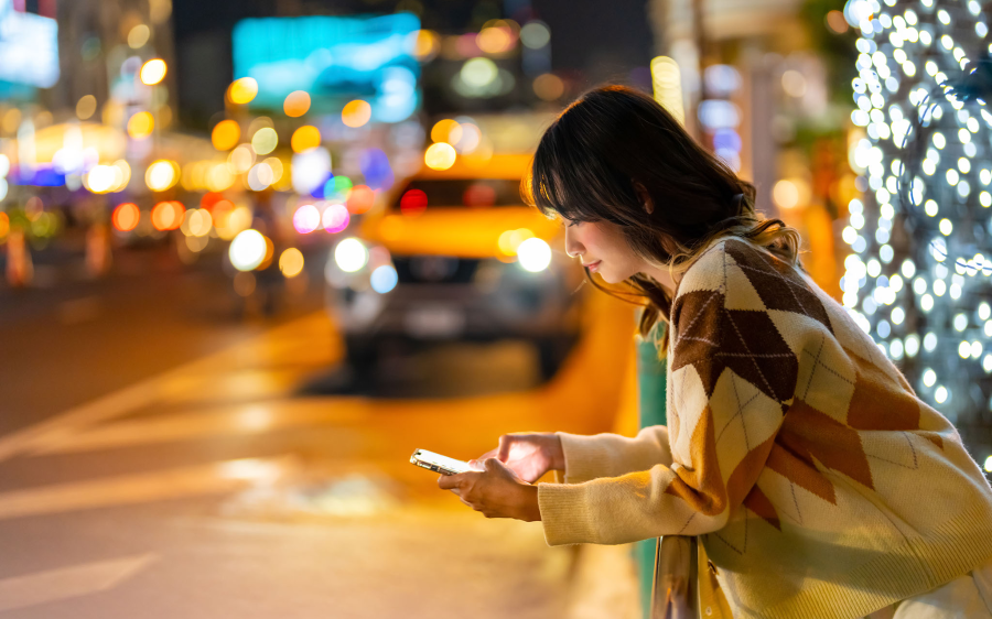 woman on phone in busy city