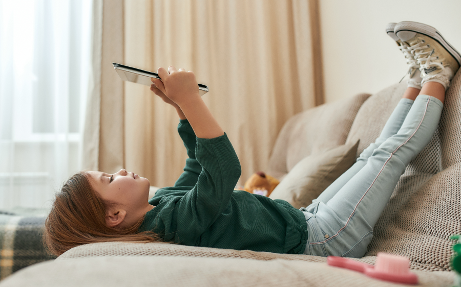 young child playing game on tablet