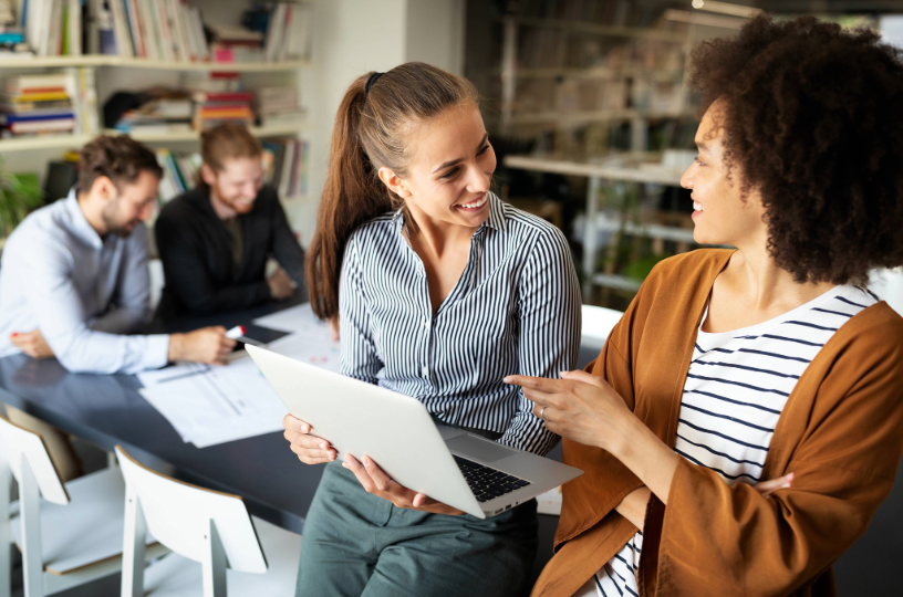 Two women working at conference table