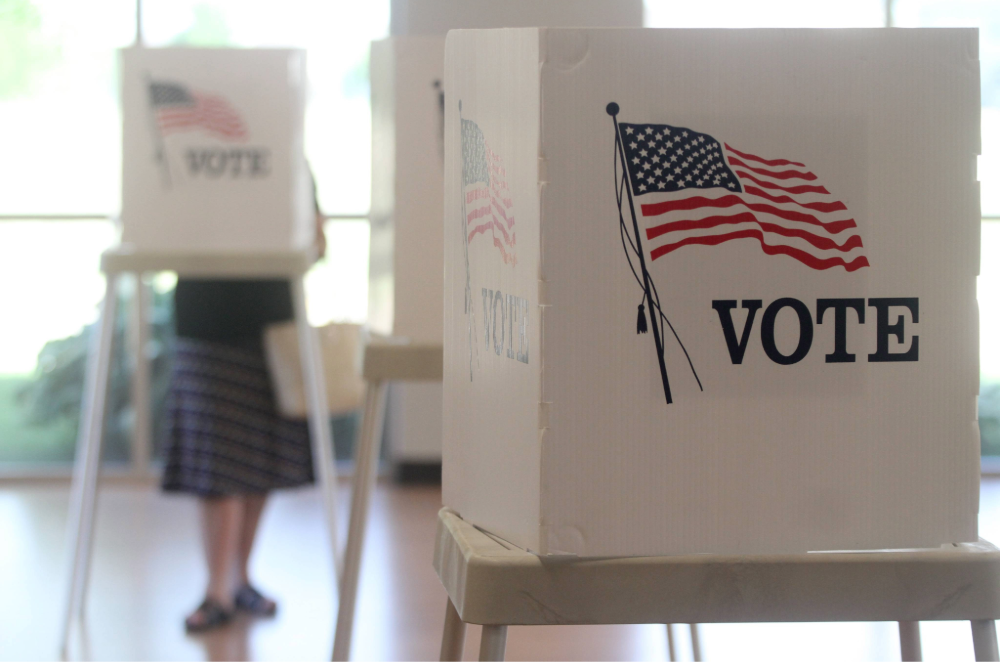 Voting booths in brightly lit room