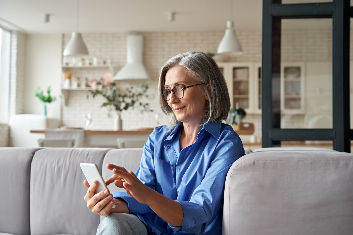 Older woman at home on her phone